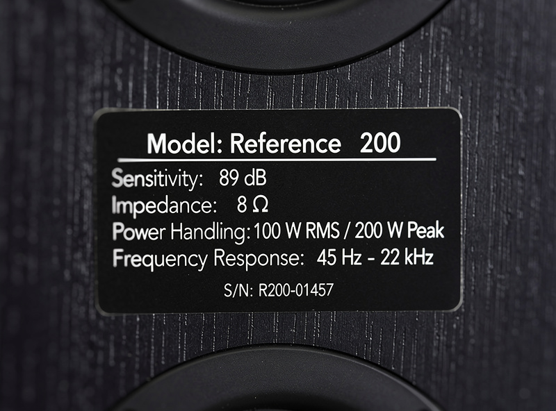 Close-up of speaker specification label showing sensitivity and impedance ratings