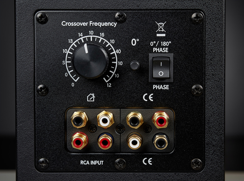 Close-up of subwoofer rear panel showing crossover knob and phase switch