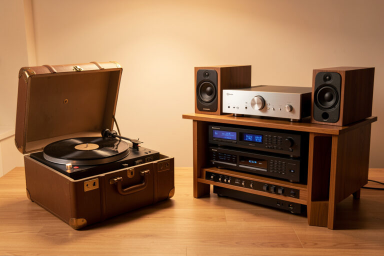 Suitcase all-in-one turntable beside a separates hi-fi system showing the upgrade path