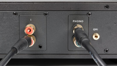 Turntable connected to a stereo integrated amplifier with RCA cables and a ground wire