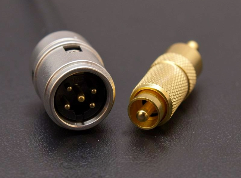 XLR balanced connector next to an RCA connector showing the difference in pins and shielding