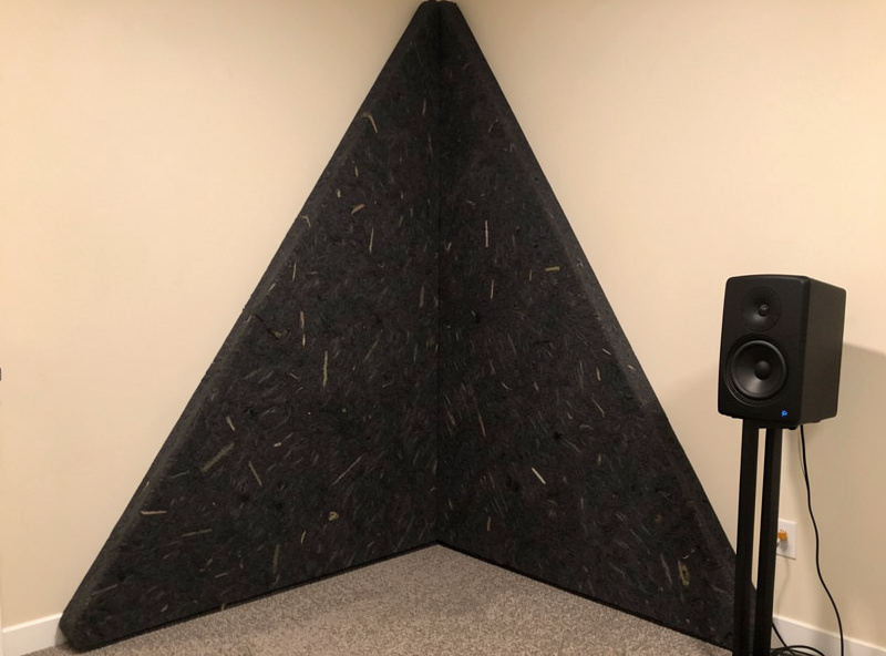 Floor-to-ceiling corner bass trap installed in the front corner of a hi-fi listening room