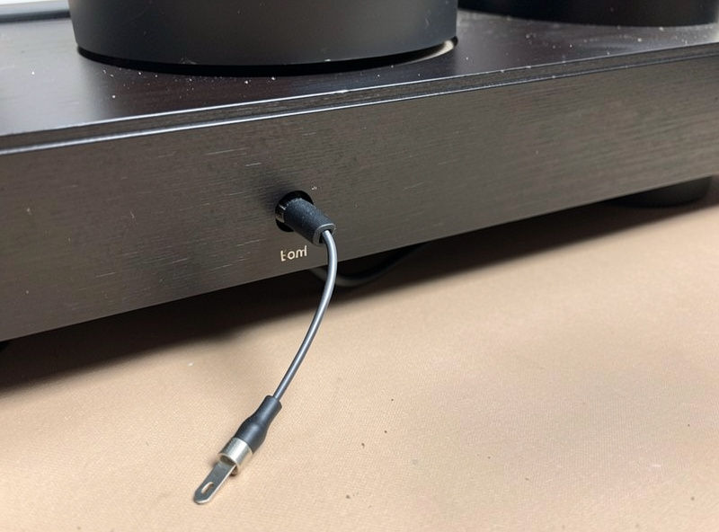 The thin turntable ground wire with a spade terminal lying loose at the back of a phono preamp